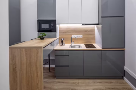 Kitchen with grey units, a microwave and breakfast bar, studio apartment on Doroshenka Street