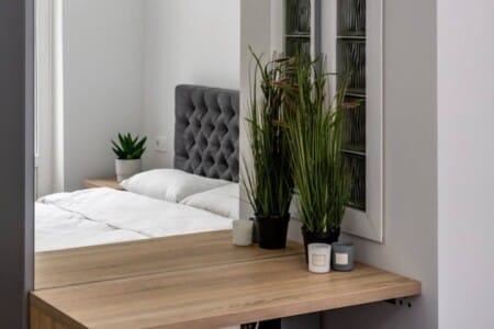 Dressing table with a mirror and pouffe in the studio apartment on Doroshenka Street
