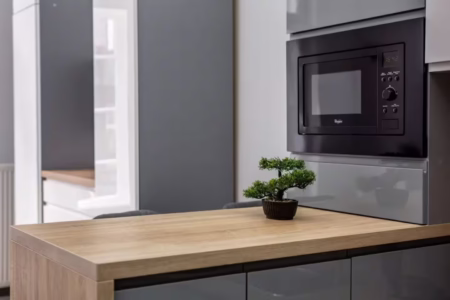 Built-in microwave and wooden worktop in the kitchen, studio apartment on Doroshenka Street