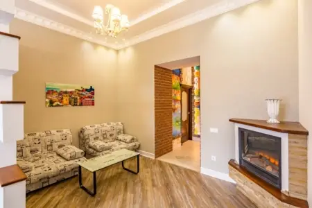 Seating area with a sofa and an electric fireplace in the apartment on Stefanyka Street