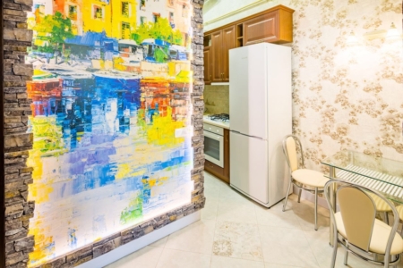 Kitchen with a colourful wall mural in the apartment on Stefanyka Street