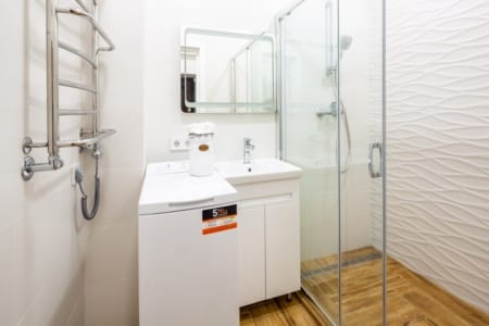 Shower cabin, washing machine and heated towel rail in the apartment on Krakivska Street
