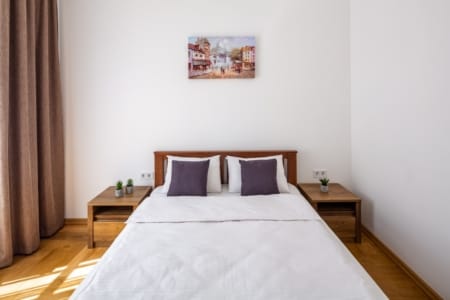Bedroom with a double bed and two bedside tables, Krakivska Street apartment