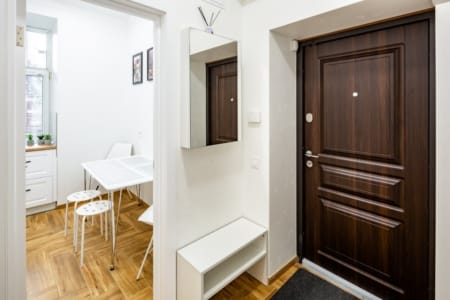 Entrance door, mirror and view into the kitchen, Krakivska Street apartment
