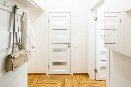 Hallway with a coat rack and doors to the rooms, Krakivska Street apartment