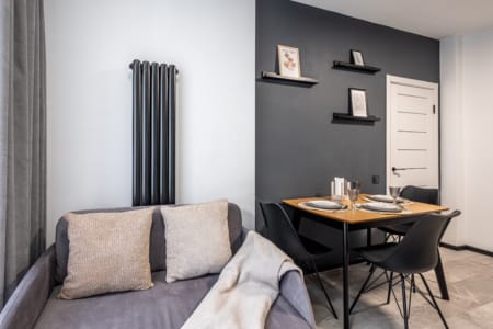 Sofa and set table in the kitchen of the apartment in the Semytsvit complex