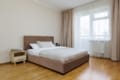 Bedroom with a double bed and balcony access in the two-bedroom apartment on Pluhova Street