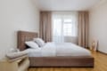 Bright bedroom with a large bed and curtains in the apartment on Pluhova Street, Lviv