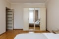 Wardrobe with mirrors and a double bed in the bedroom of the apartment on Pluhova Street