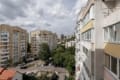 Window view of the buildings and greenery, two-bedroom apartment on Pluhova Street