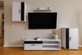 Wall-mounted TV and TV unit in the living room of the apartment on Pluhova Street
