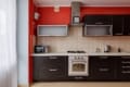 Kitchen units with a gas hob, oven and cooker hood in the apartment on Pluhova Street