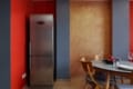 Fridge and dining table in the kitchen of the apartment on Pluhova Street