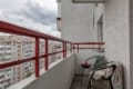 Balcony with chairs and a city view in the apartment on Pluhova Street