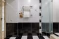 Heated towel rail and shower cabin in the bathroom of the apartment on Pluhova Street
