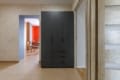Entrance hall with a dark wardrobe in the two-bedroom apartment on Pluhova Street