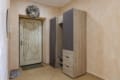 Entrance door and a wardrobe with shelves in the hallway of the apartment on Pluhova Street