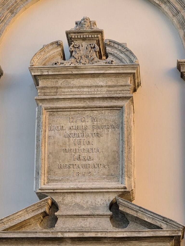 Латинський напис на фасаді Гарнізонного храму: закладено 1610, освячено 1630, відновлено 1842
